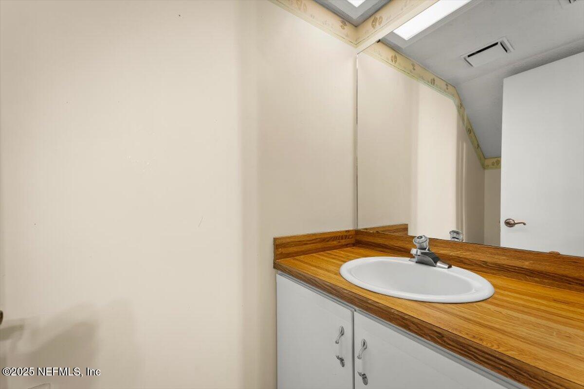 3801 Crown Point Road, Unit 3073 Jacksonville, FL 32257 - Photo 26 of 26 a bathroom with a sink and a mirror