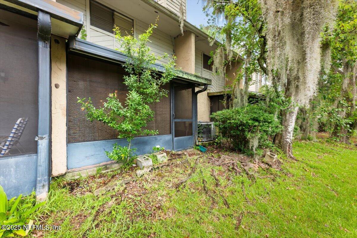 3801 Crown Point Road, Unit 3073 Jacksonville, FL 32257 - Photo 4 of 26 a view of a house with a yard and plants