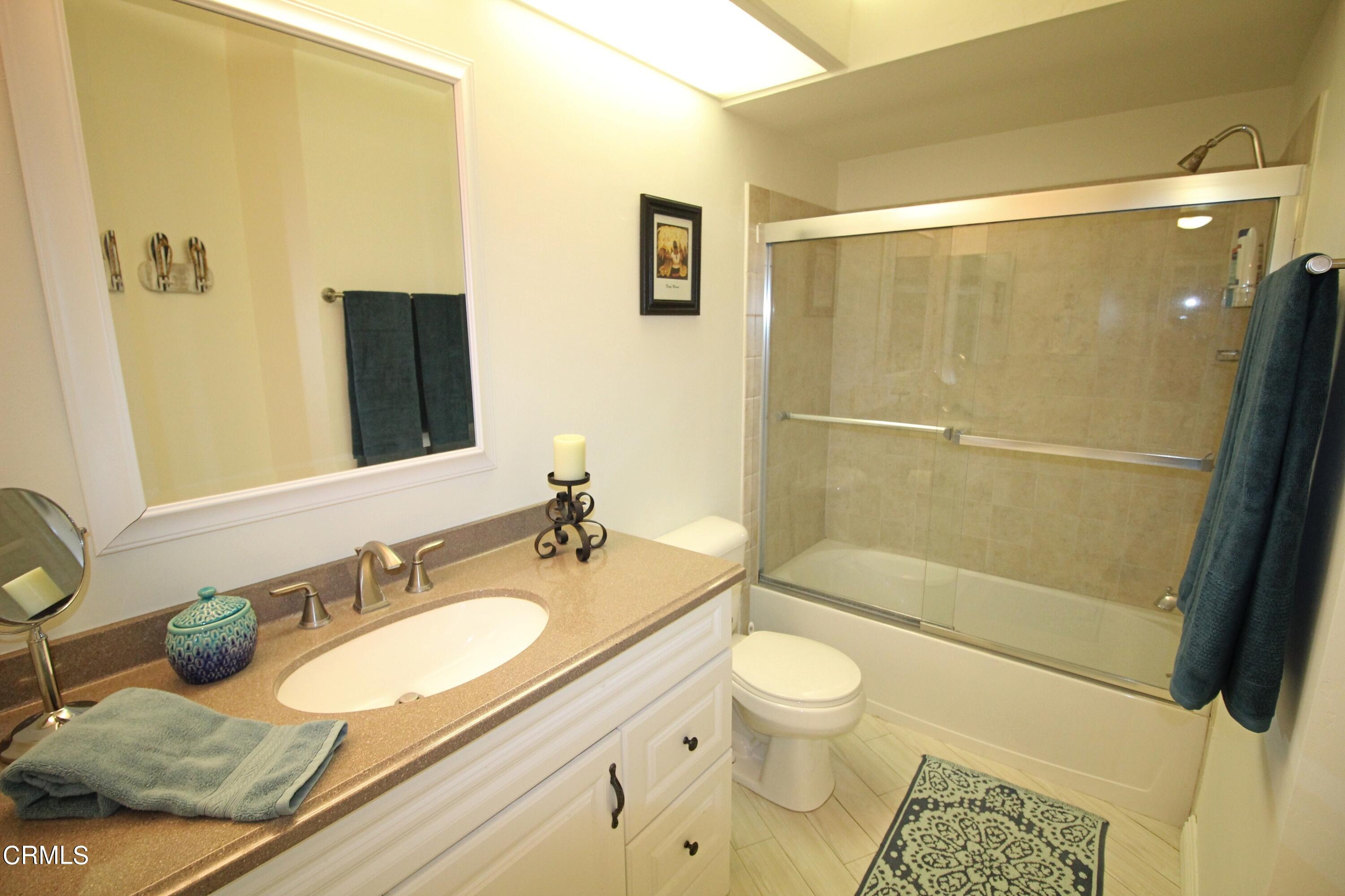 3101 Peninsula Road, Unit 312 Oxnard, CA 93035 - Photo 12 of 26 a bathroom with a granite countertop sink toilet and shower