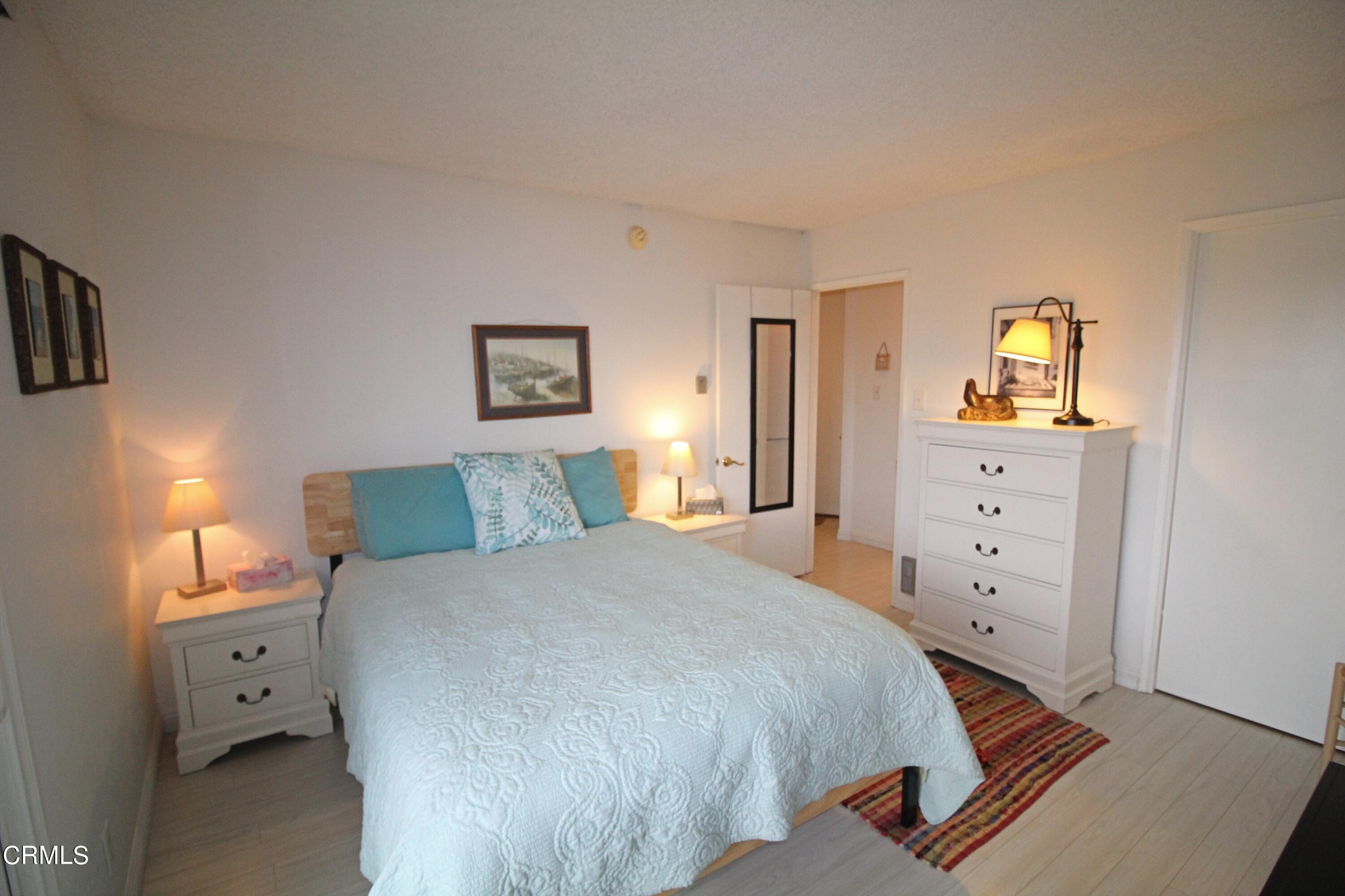 3101 Peninsula Road, Unit 312 Oxnard, CA 93035 - Photo 14 of 26 a bedroom with a bed and a dresser