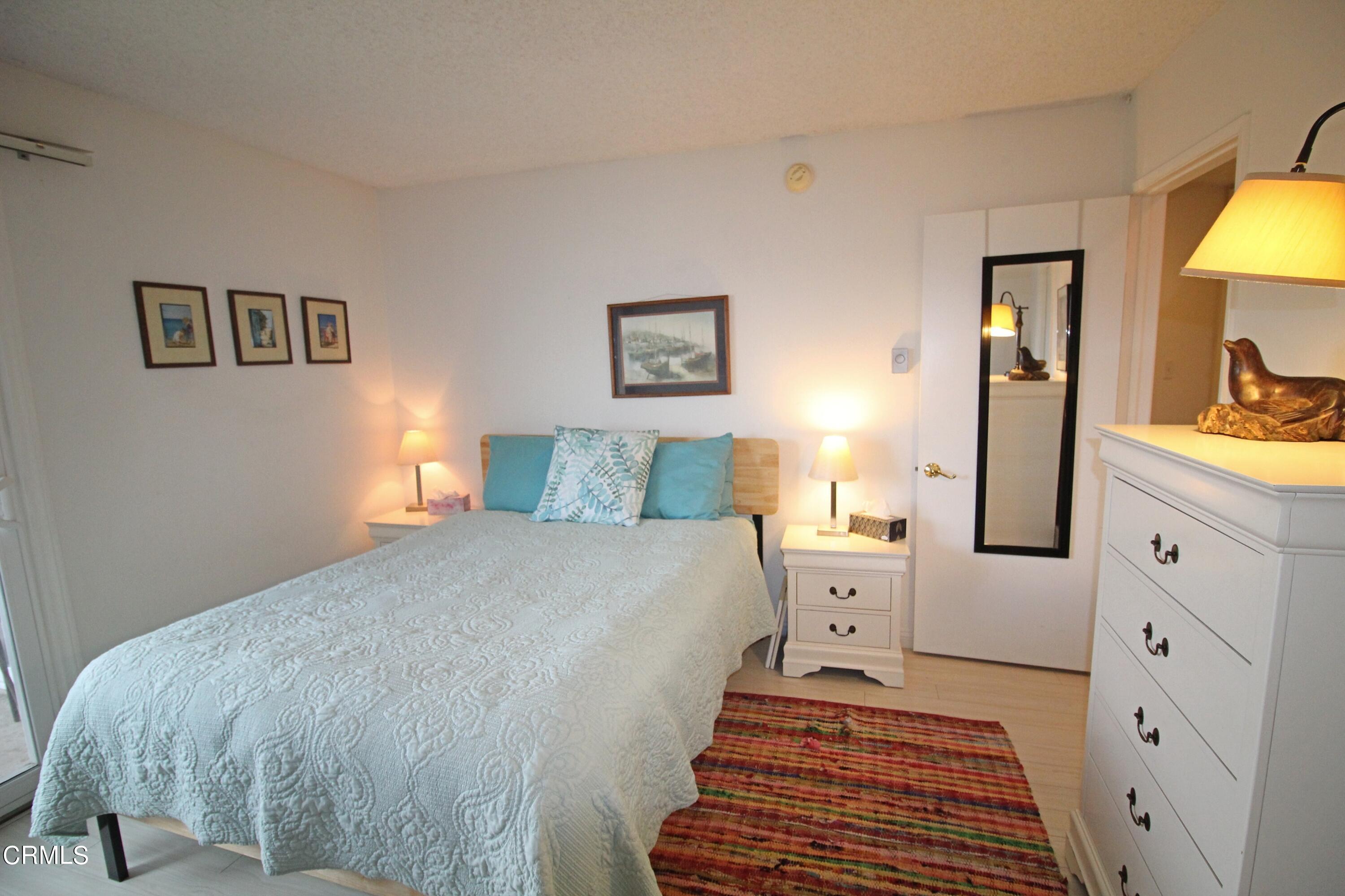 3101 Peninsula Road, Unit 312 Oxnard, CA 93035 - Photo 16 of 26 a bedroom with a bed and a couch