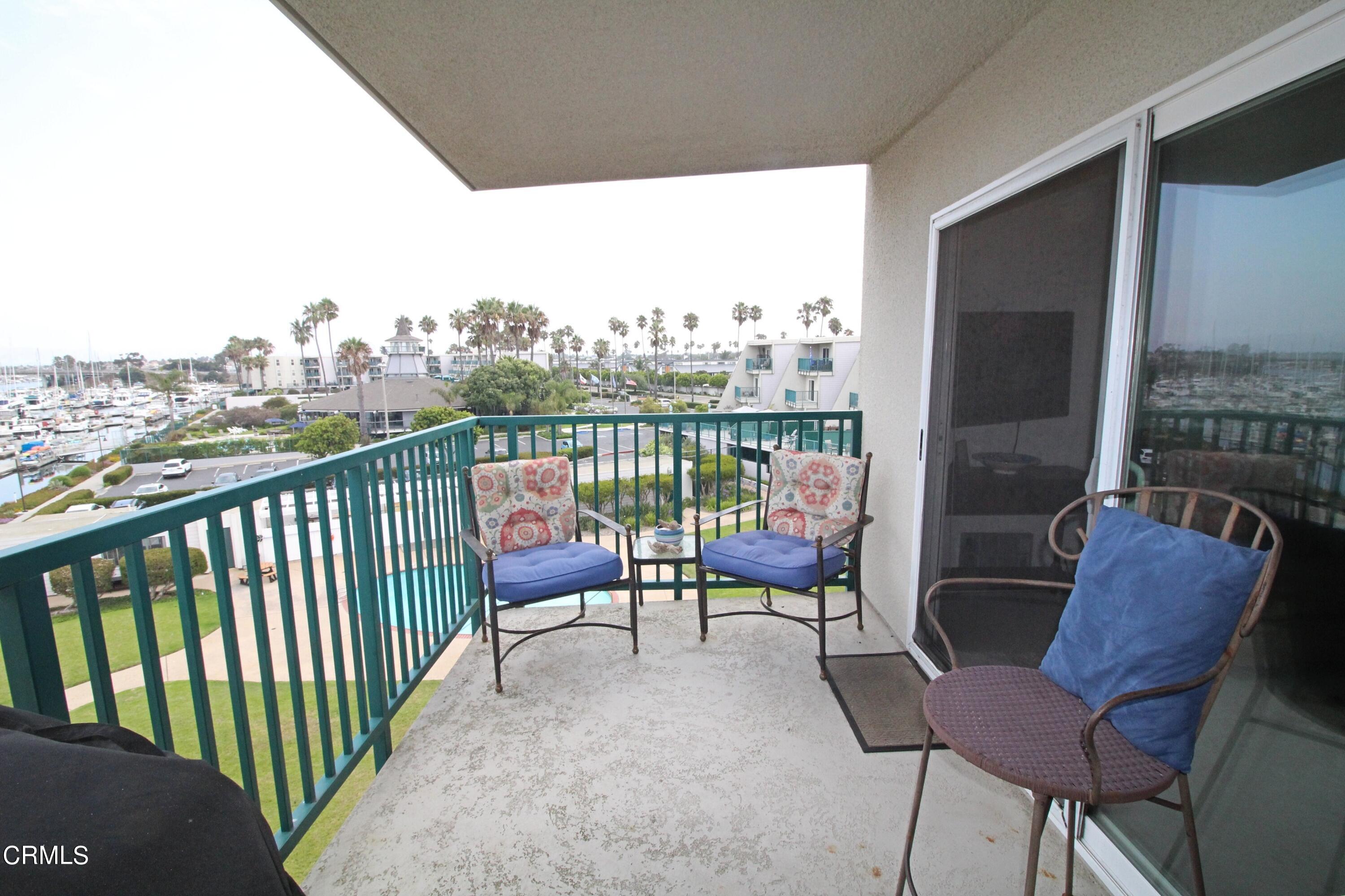 3101 Peninsula Road, Unit 312 Oxnard, CA 93035 - Photo 18 of 26 a balcony with an outdoor seating