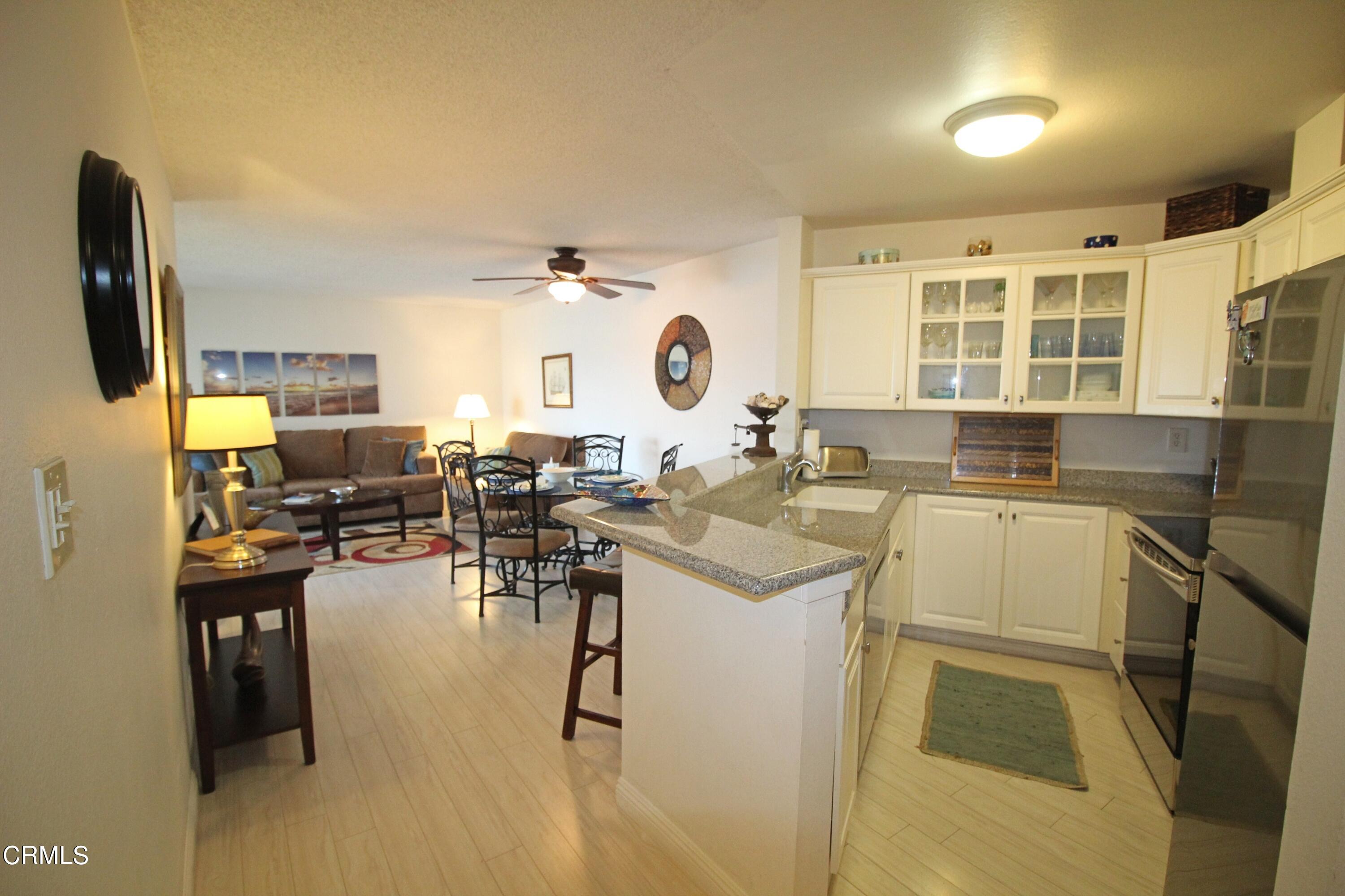 3101 Peninsula Road, Unit 312 Oxnard, CA 93035 - Photo 2 of 26 a kitchen with a sink stove and cabinets