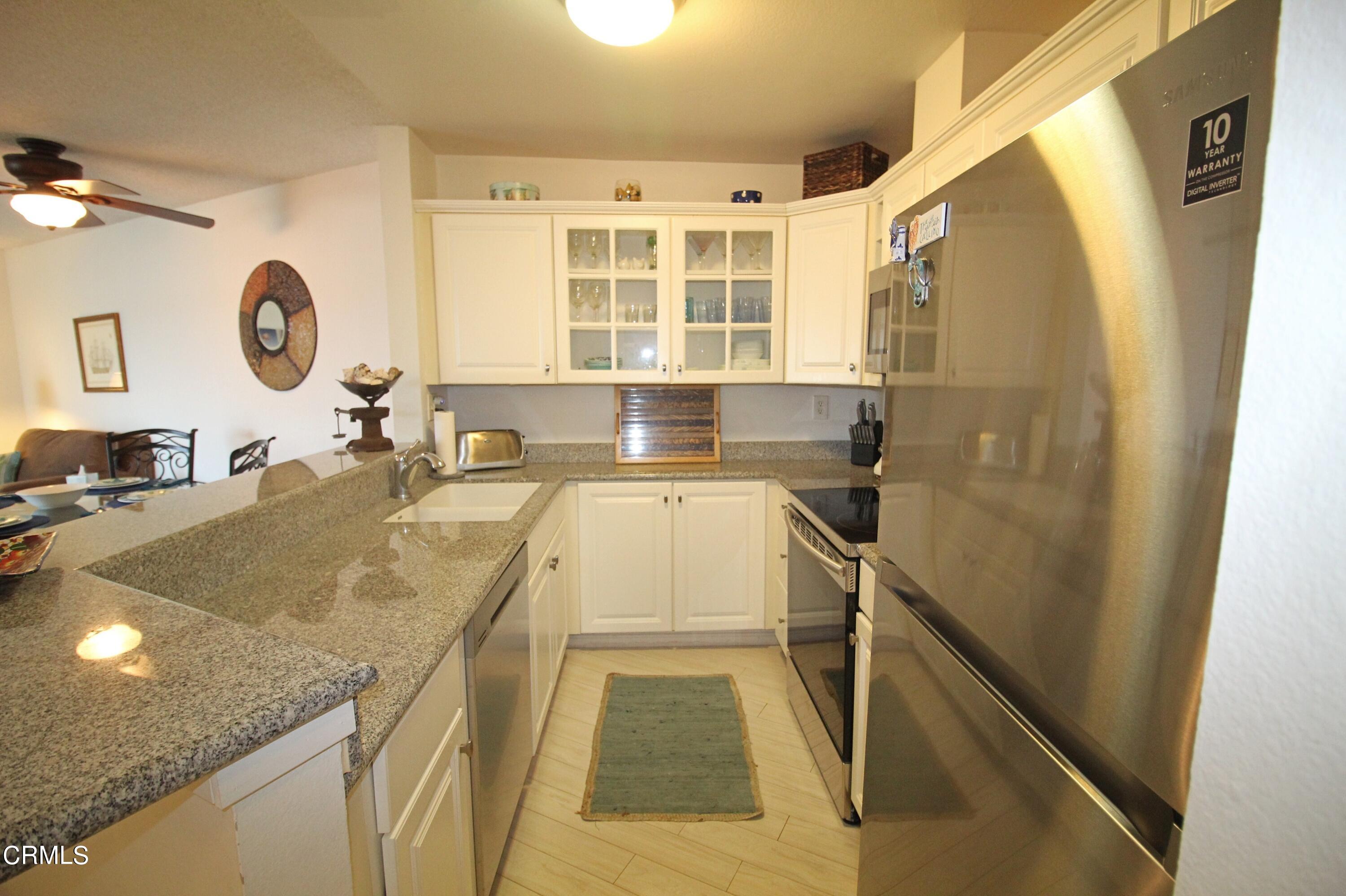 3101 Peninsula Road, Unit 312 Oxnard, CA 93035 - Photo 3 of 26 a bathroom with a granite countertop sink and a mirror