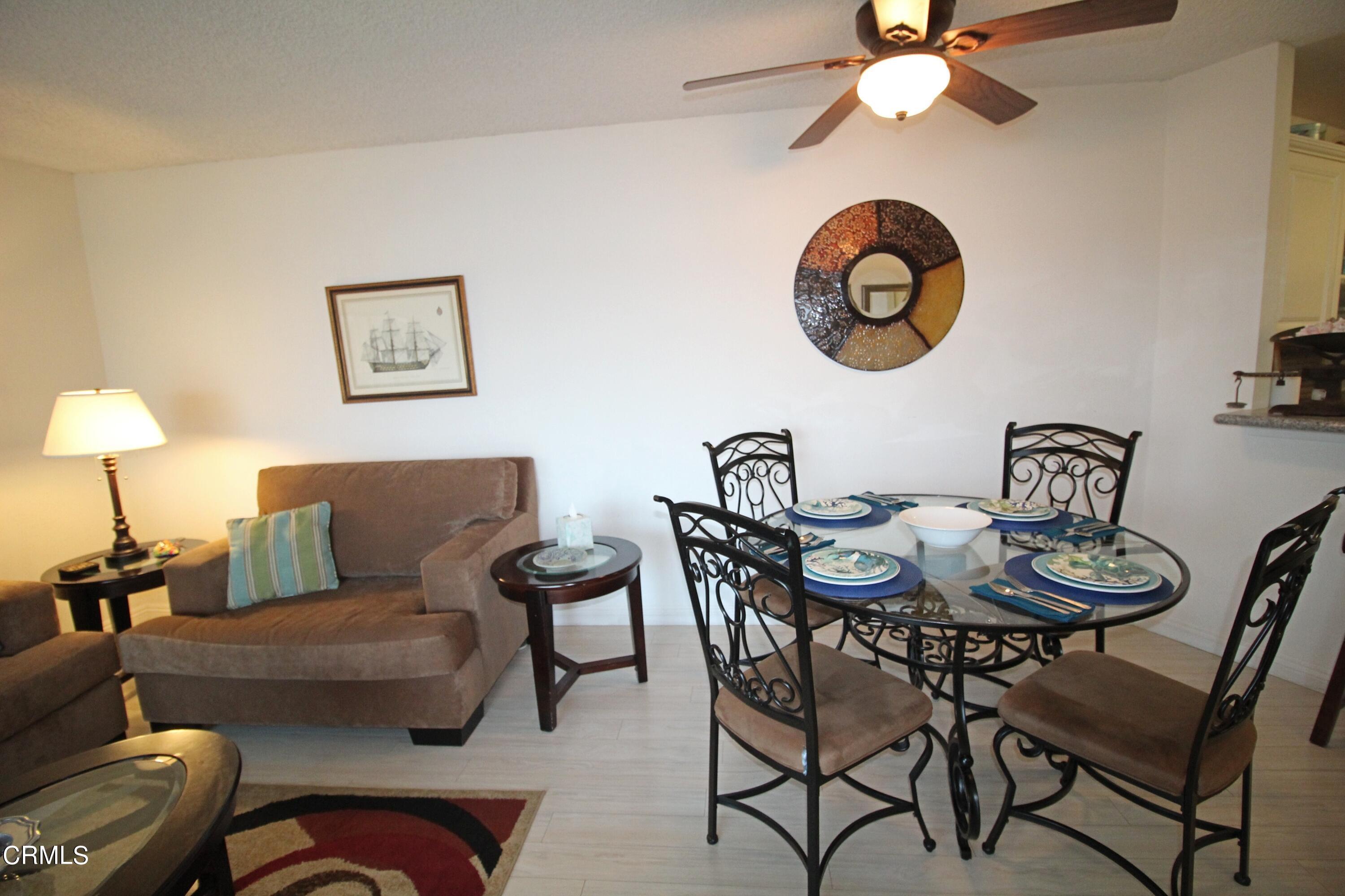 3101 Peninsula Road, Unit 312 Oxnard, CA 93035 - Photo 7 of 26 a living room with furniture a rug and a wall painting