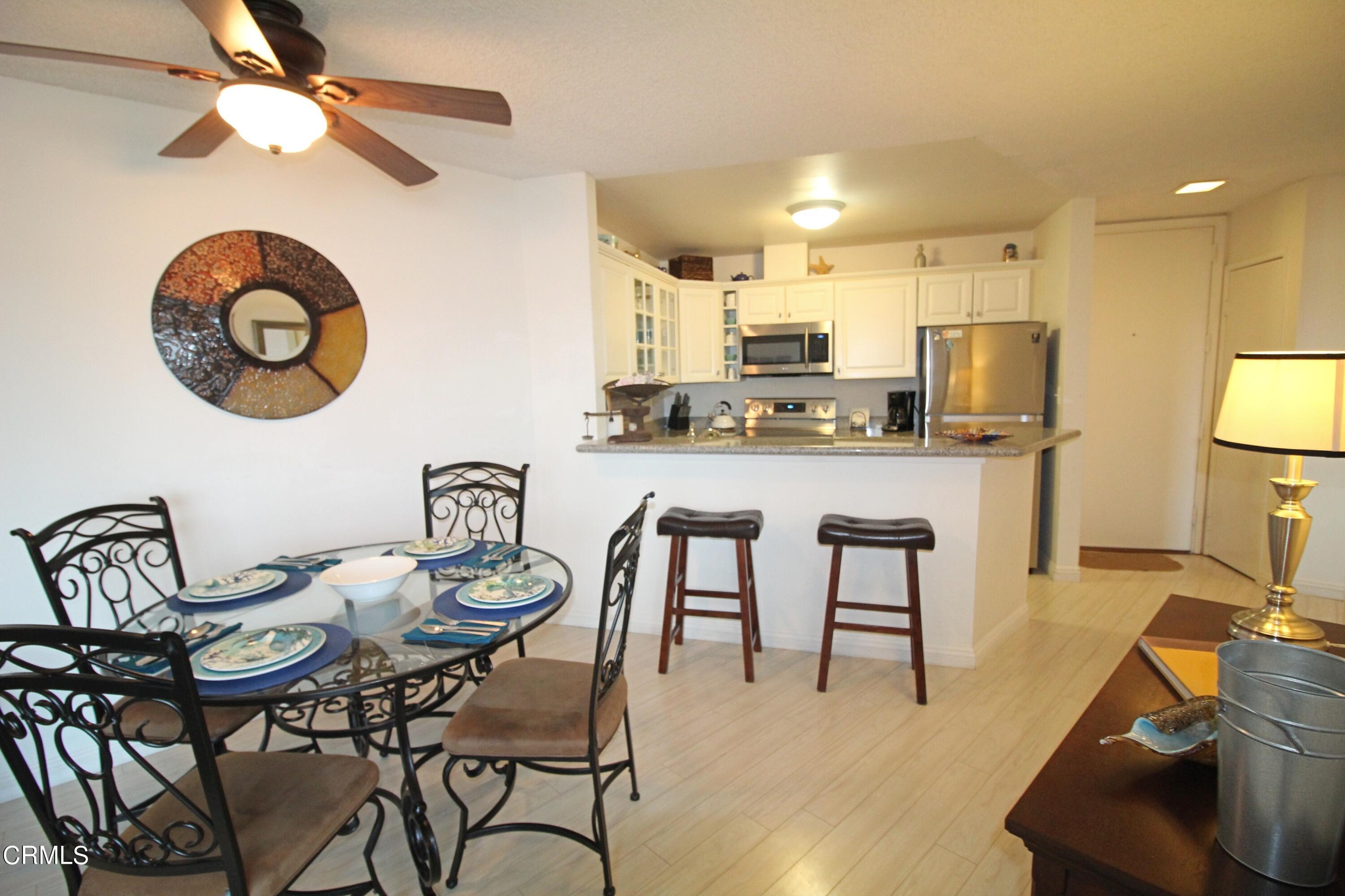 3101 Peninsula Road, Unit 312 Oxnard, CA 93035 - Photo 8 of 26 a view of a dining room with furniture and a chandelier