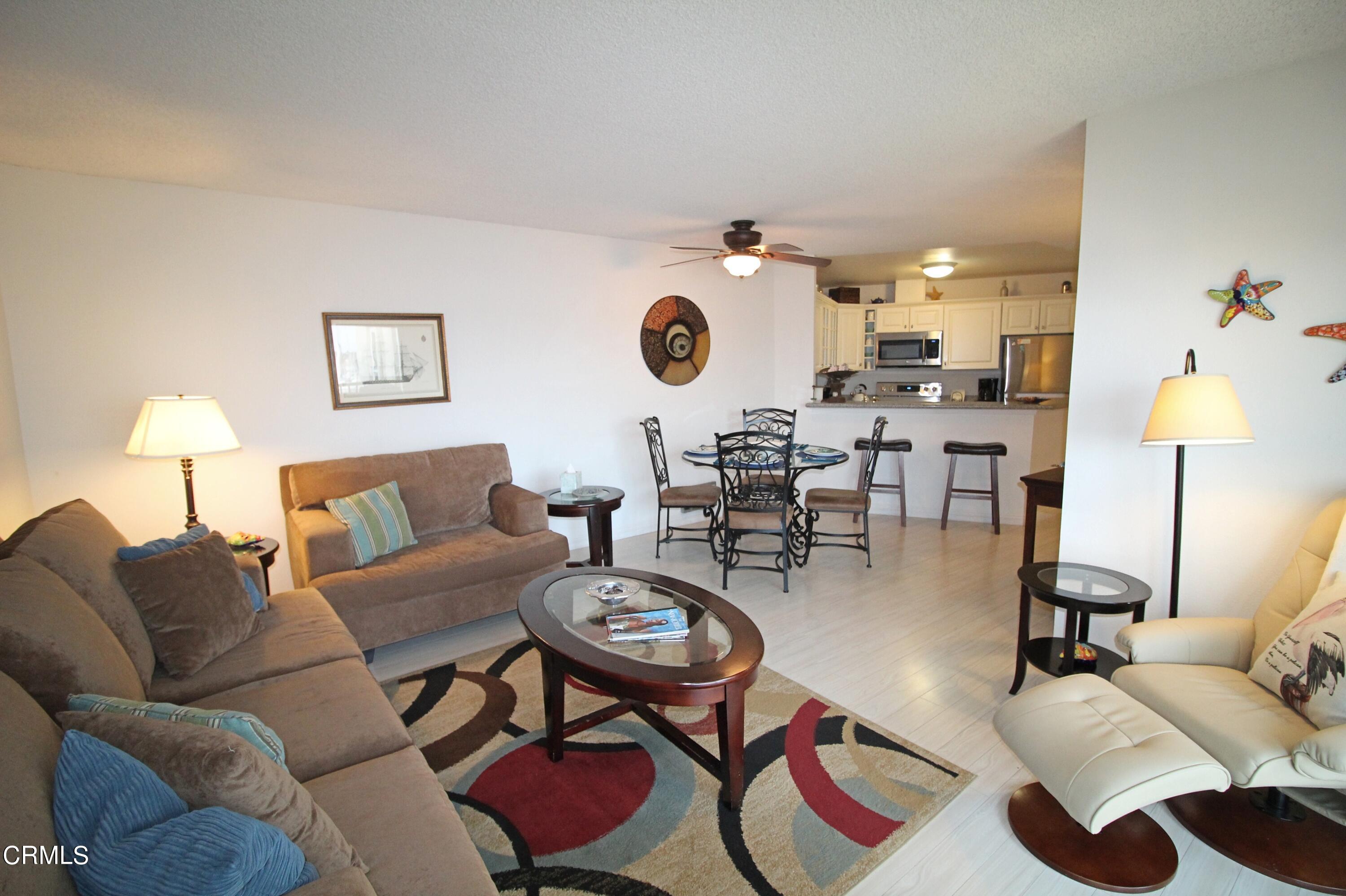 3101 Peninsula Road, Unit 312 Oxnard, CA 93035 - Photo 9 of 26 a living room with furniture and wooden floor