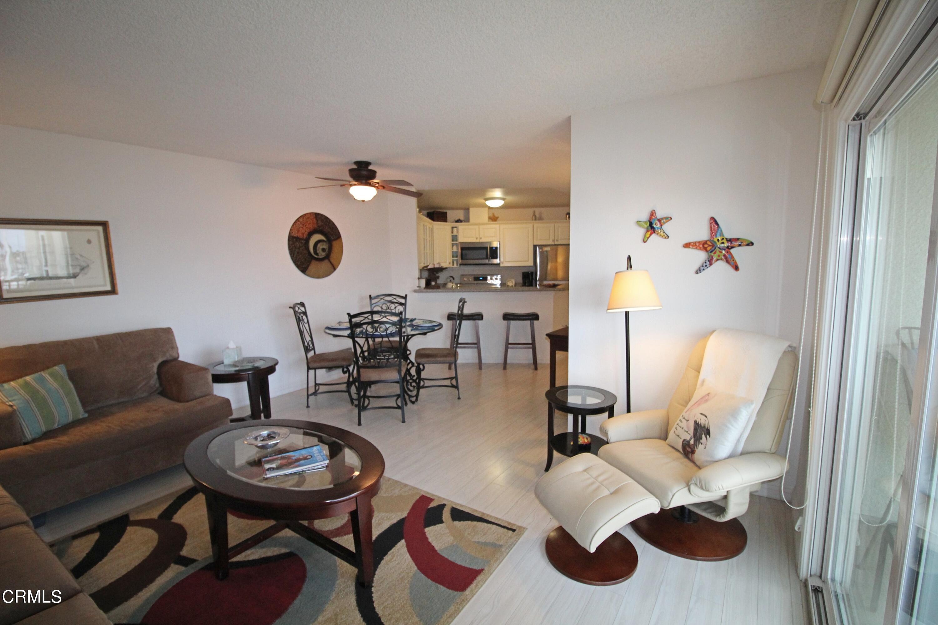 3101 Peninsula Road, Unit 312 Oxnard, CA 93035 - Photo 10 of 26 a living room with furniture and a mirror