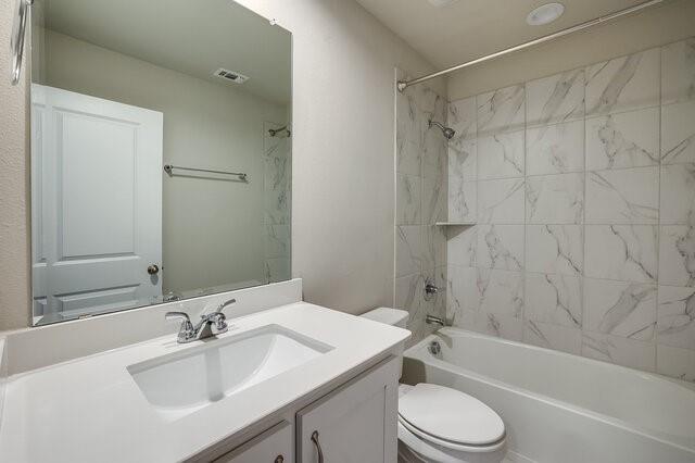 5912 Bursey Road Watauga, TX 76148 - Photo 11 of 23 Bathroom featuring toilet, vanity, and bathing tub / shower combination