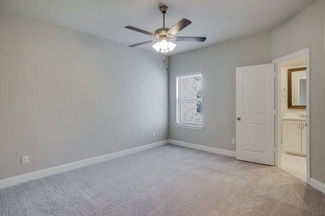 5912 Bursey Road Watauga, TX 76148 - Photo 19 of 23 Spare room featuring light colored carpet, a ceiling fan, and baseboards
