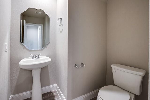 5912 Bursey Road Watauga, TX 76148 - Photo 20 of 23 Half bathroom featuring toilet and baseboards