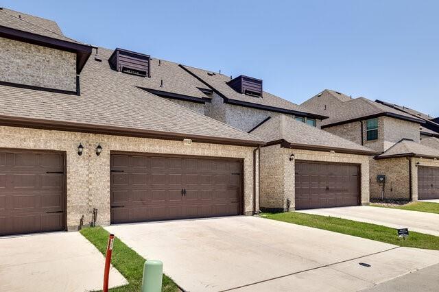 5912 Bursey Road Watauga, TX 76148 - Photo 23 of 23 View of front of house featuring concrete driveway, a shingled roof, and an attached garage