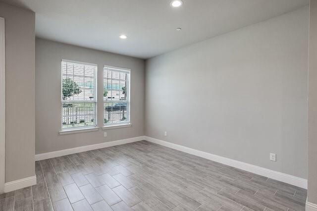 5912 Bursey Road Watauga, TX 76148 - Photo 10 of 23 Spare room featuring light wood-style floors, baseboards, and recessed lighting