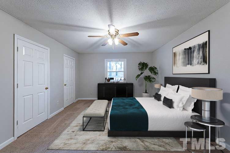 7005 Russell Road Durham, NC 27712 - Photo 11 of 24 a bedroom with a bed and glass table
