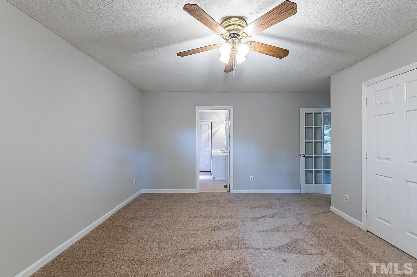 7005 Russell Road Durham, NC 27712 - Photo 13 of 24 an empty room with chandelier fan
