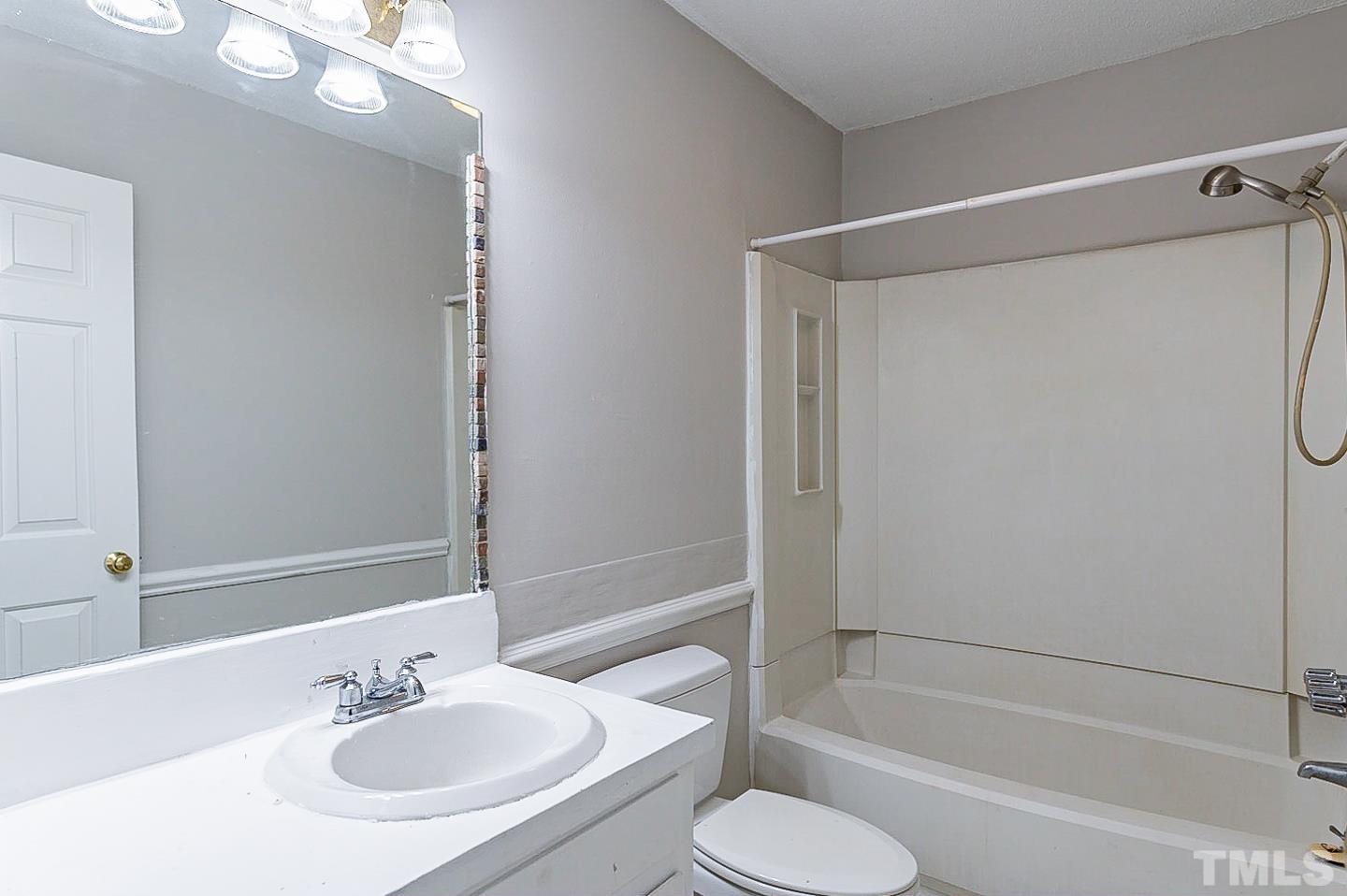 7005 Russell Road Durham, NC 27712 - Photo 16 of 24 a bathroom with a sink toilet and shower