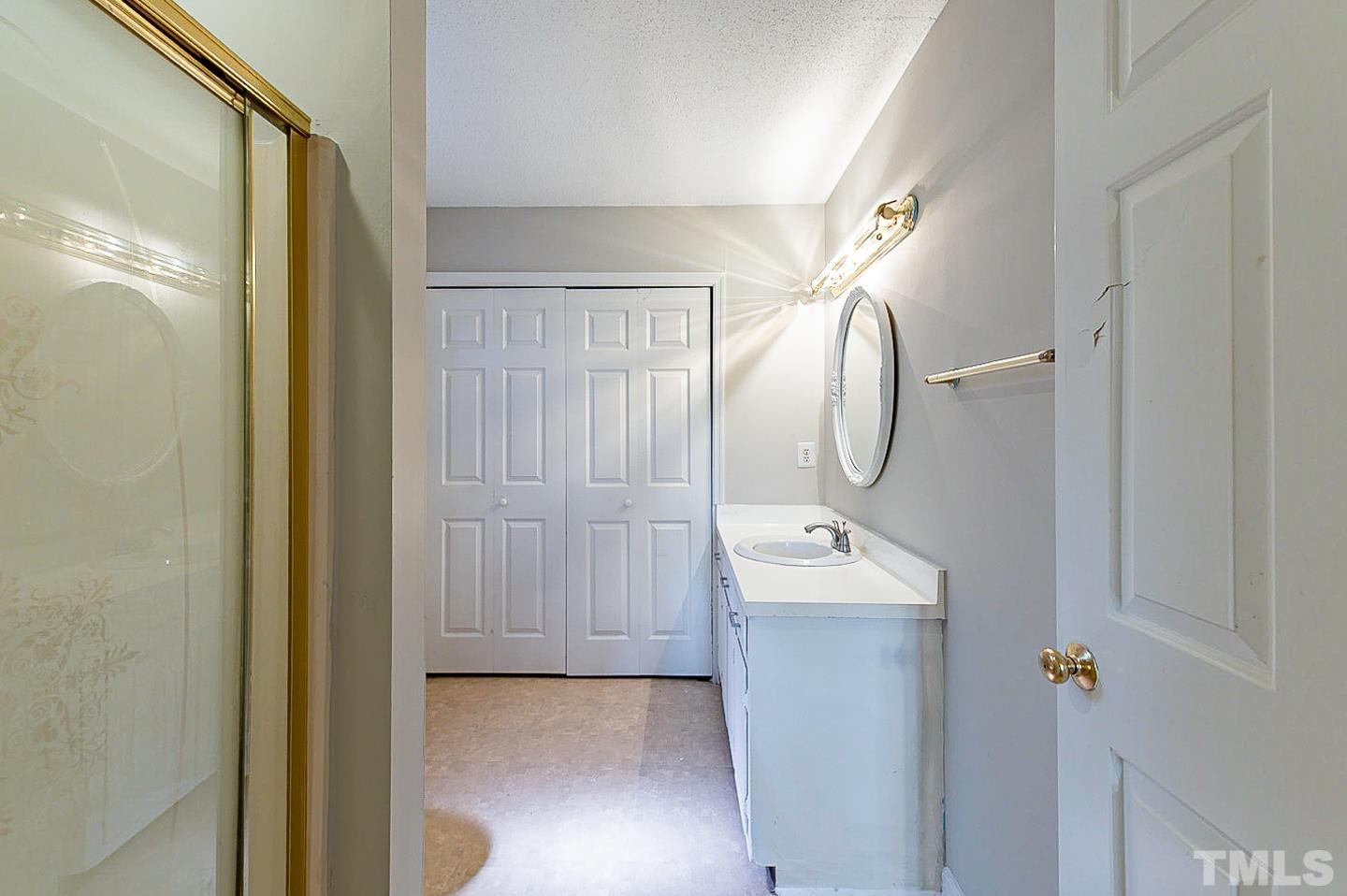 7005 Russell Road Durham, NC 27712 - Photo 17 of 24 a bathroom with a sink mirror and vanity