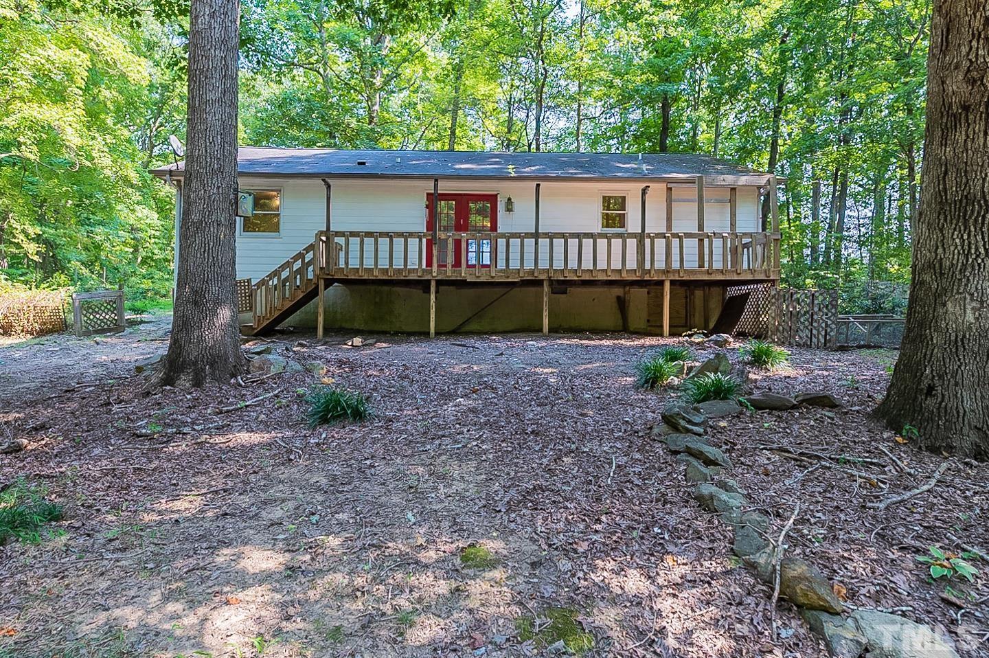 7005 Russell Road Durham, NC 27712 - Photo 22 of 24 a view of a house with a yard and floor to ceiling window