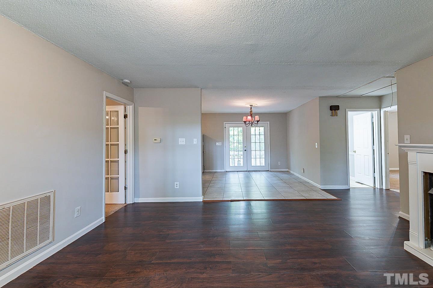 7005 Russell Road Durham, NC 27712 - Photo 5 of 24 a view of empty room with wooden floor
