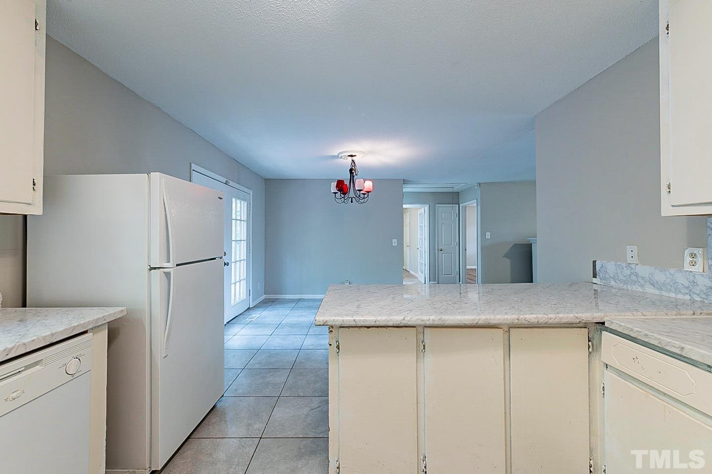 7005 Russell Road Durham, NC 27712 - Photo 6 of 24 a kitchen with a granite countertop refrigerator and a sink
