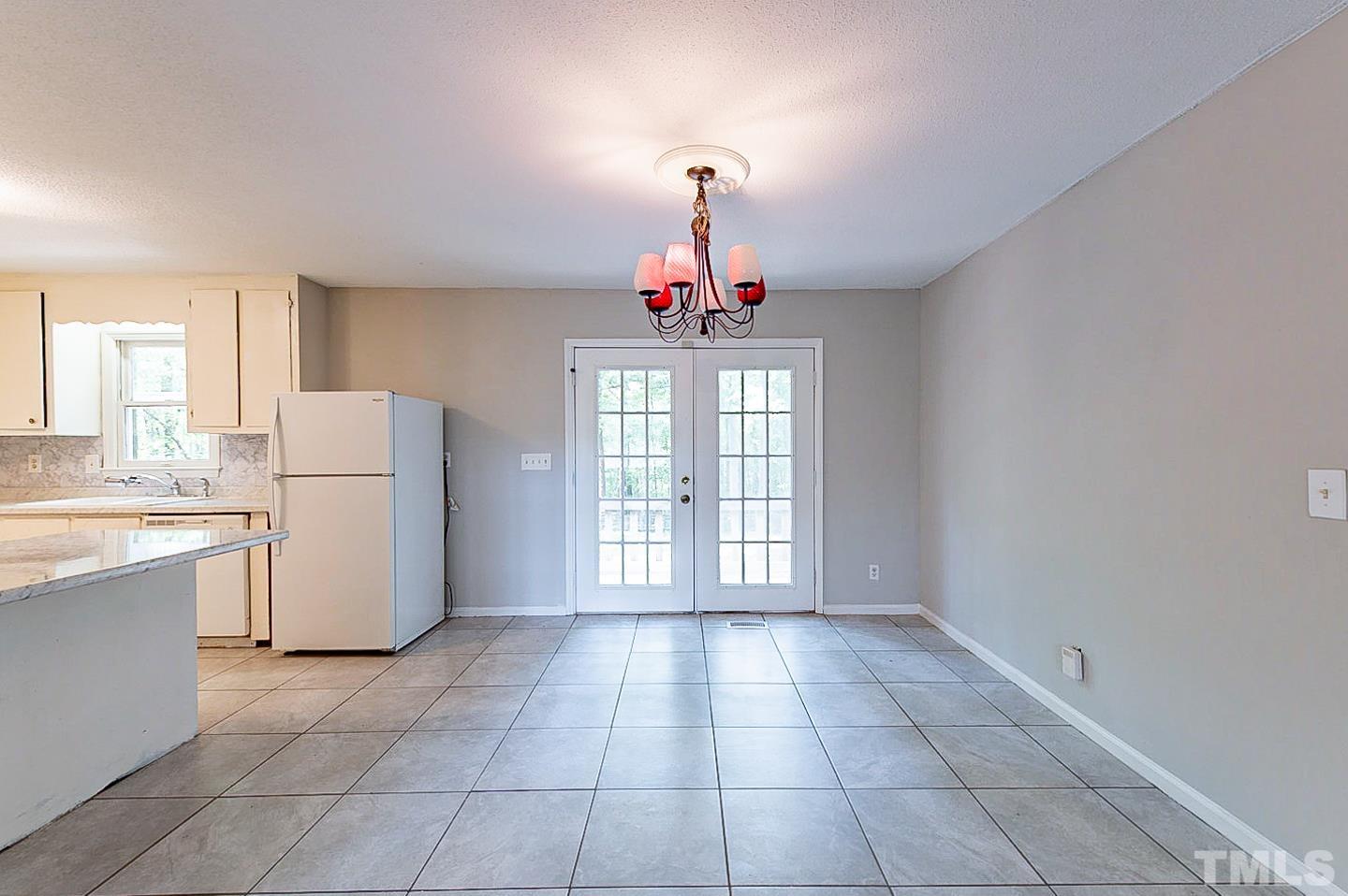 7005 Russell Road Durham, NC 27712 - Photo 10 of 24 a view of a kitchen with a stove cabinets and a large window