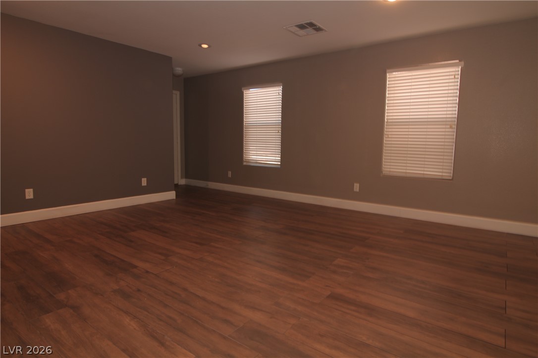 9289 Valley Ranch Avenue Las Vegas, NV 89178 - Photo 10 of 29 Rich hardwood floors span this generously proportioned room, offering a versatile space for living or dining.
