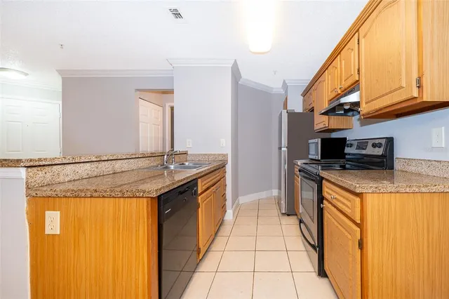 a kitchen with stainless steel appliances granite countertop a sink and a stove