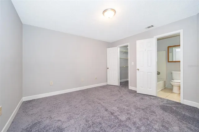 a view of an empty room and a bathroom