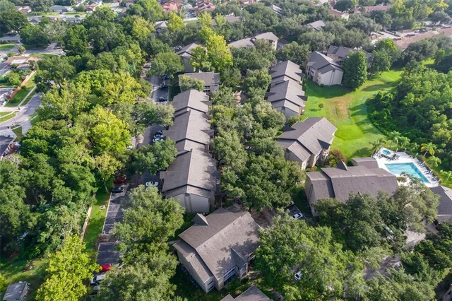 an aerial view of a house with a yard and garden