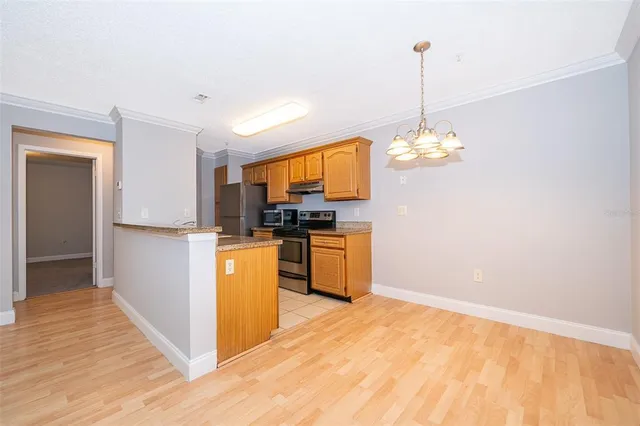 a kitchen with a refrigerator and microwave