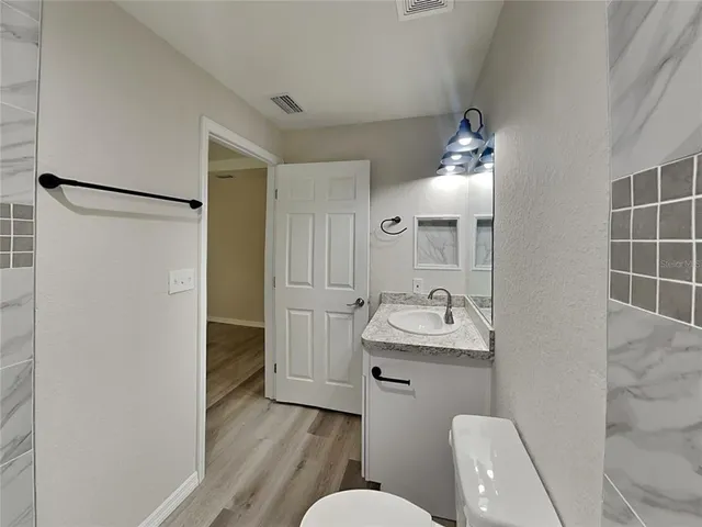a bathroom with a sink toilet and shower
