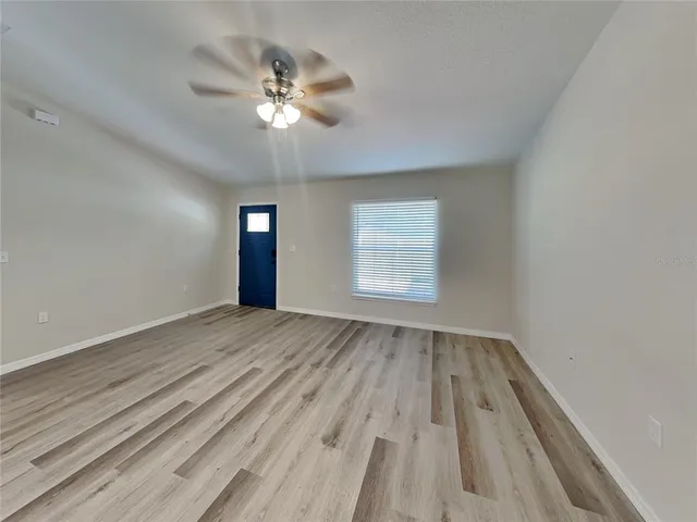 wooden floor in an empty room with a window