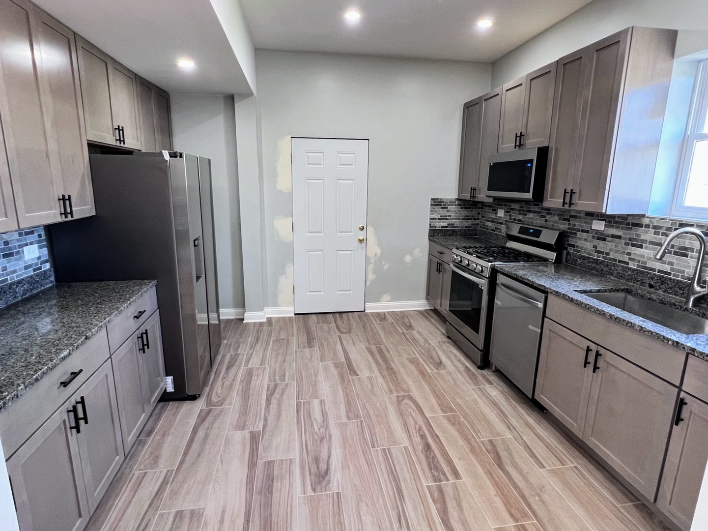 4244 North Spaulding Avenue, Unit 3 Chicago, IL 60618 - Photo 2 of 16 a kitchen with stainless steel appliances granite countertop a stove and a refrigerator