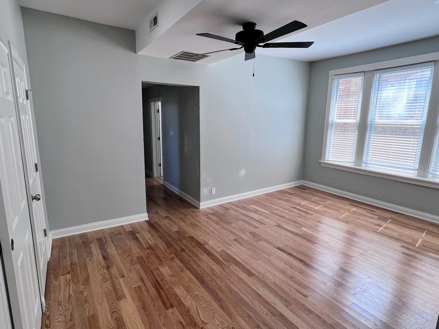 4244 North Spaulding Avenue, Unit 3 Chicago, IL 60618 - Photo 6 of 16 wooden floor in an empty room with a window
