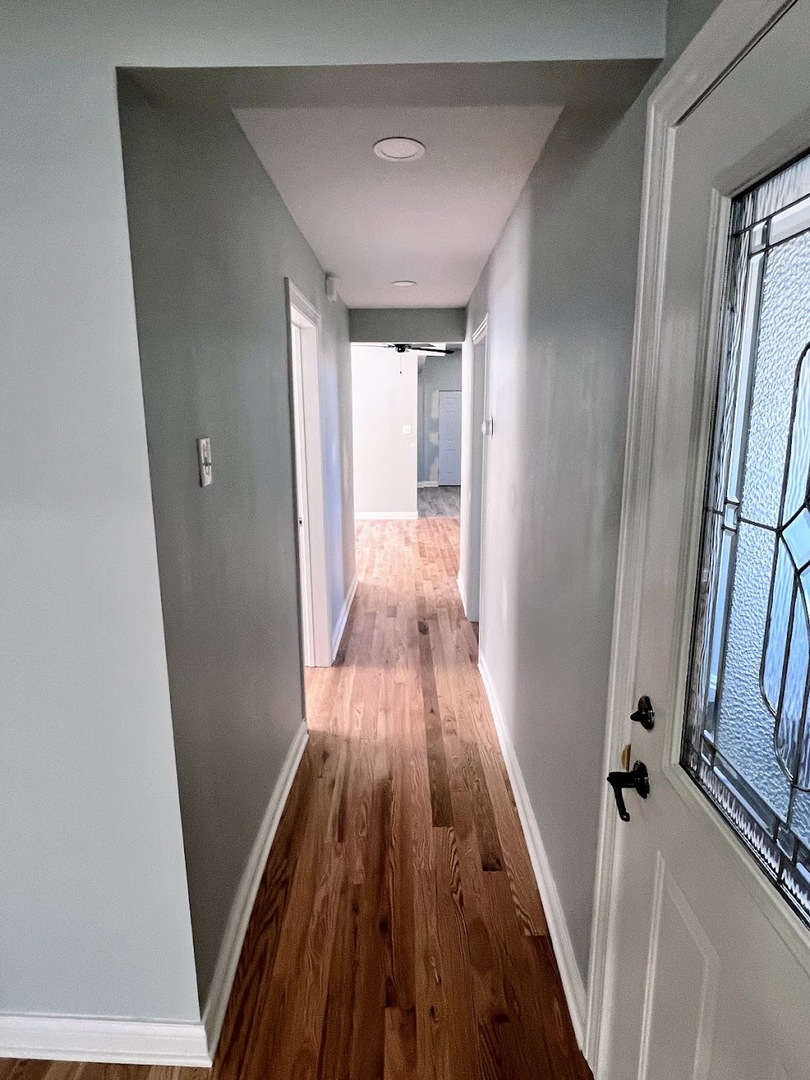 4244 North Spaulding Avenue, Unit 3 Chicago, IL 60618 - Photo 9 of 16 a view of a hallway with wooden floor and staircase