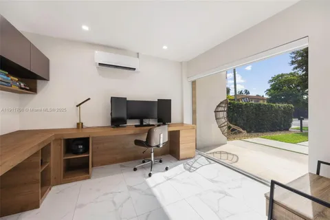 a view of a workspace with furniture