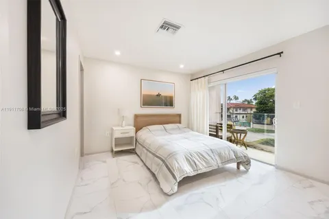 a bedroom with a bed and large window