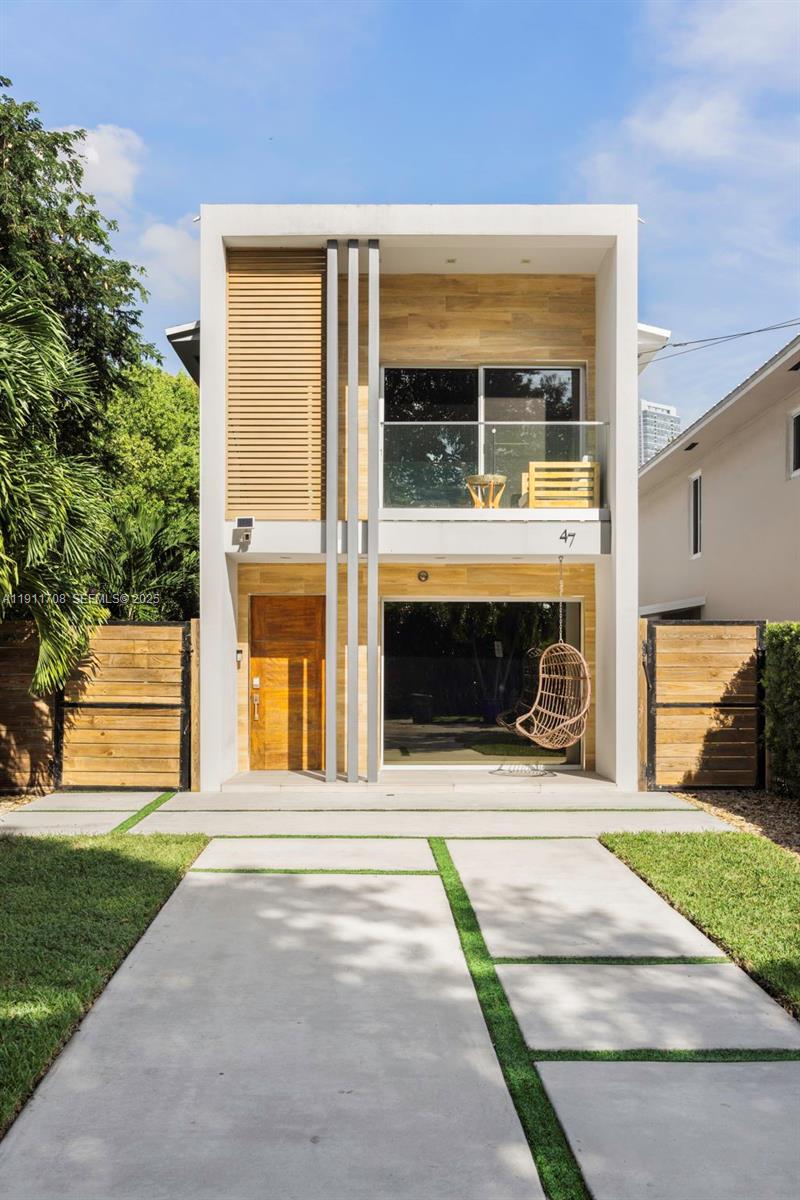47 Southwest 21st Road Miami, FL 33129 - Photo 2 of 28 a view of a house with a garden and pathway