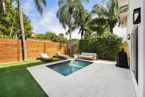 a view of a swimming pool with a table and chairs