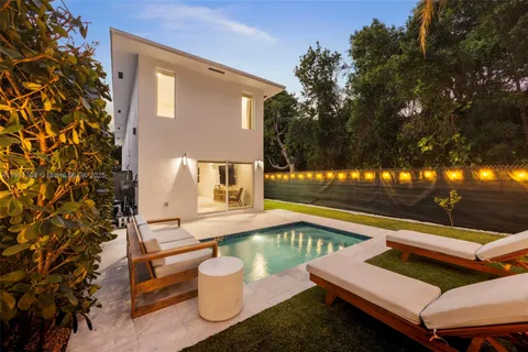 a view of a patio with chairs and a potted plant