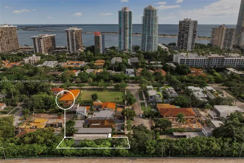 an aerial view of residential houses with outdoor space and swimming pool