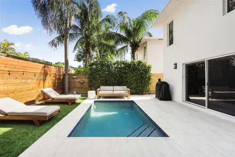 a view of a patio with swimming pool table and chairs