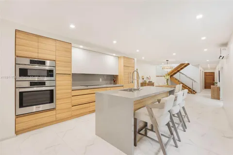 a kitchen with a sink stainless steel appliances and cabinets