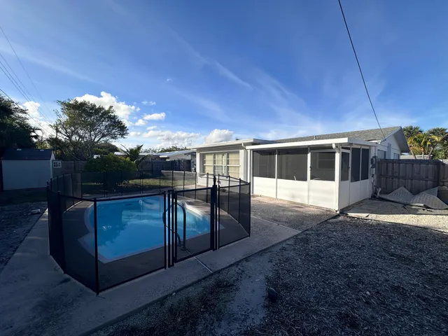 a view of house with backyard and kitchen
