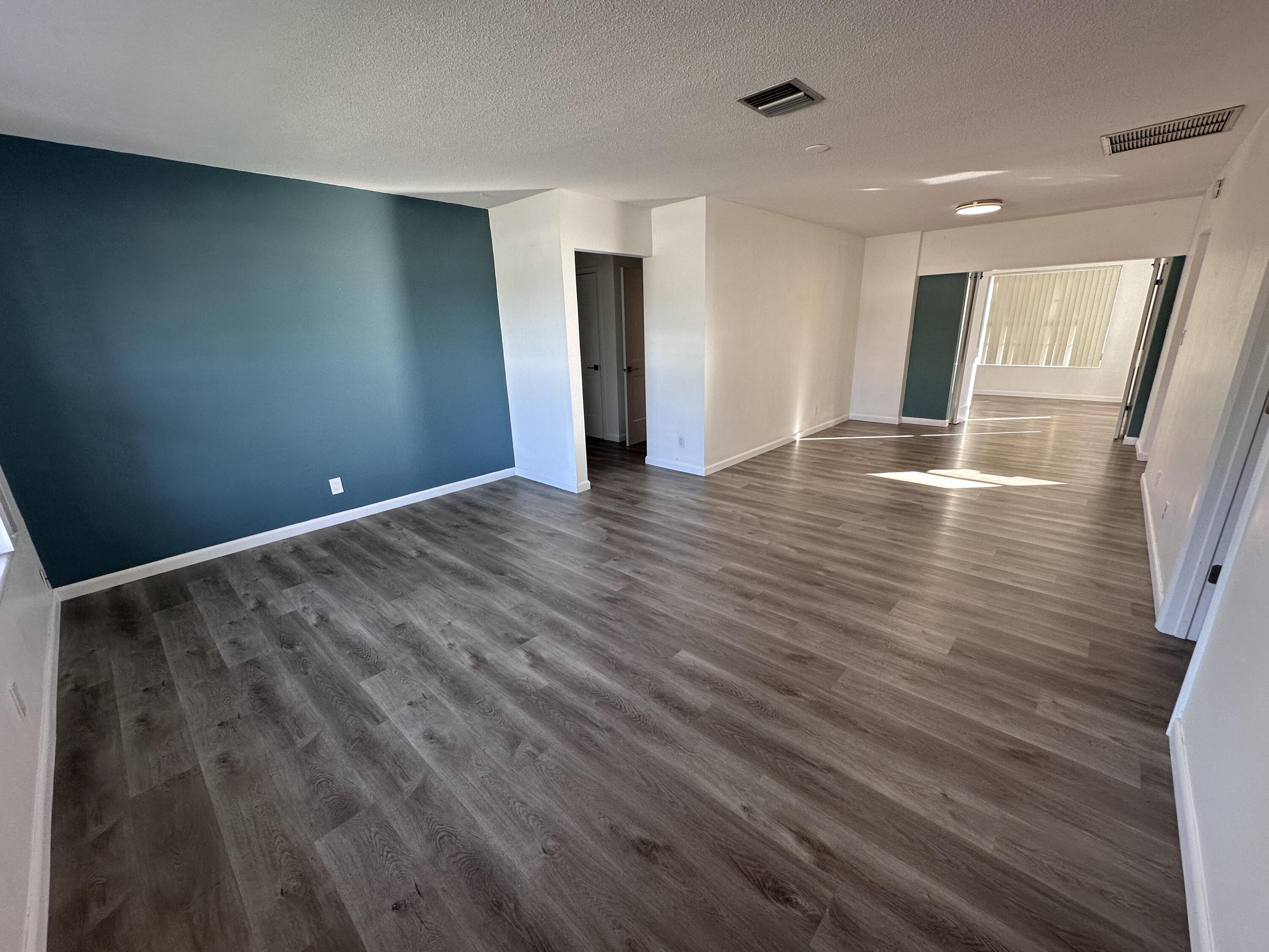 14 Ridgewood Circle Tequesta, FL 33469 - Photo 2 of 24 a view of empty room with wooden floor