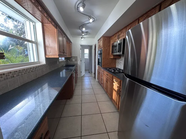 a view of a hallway with furniture