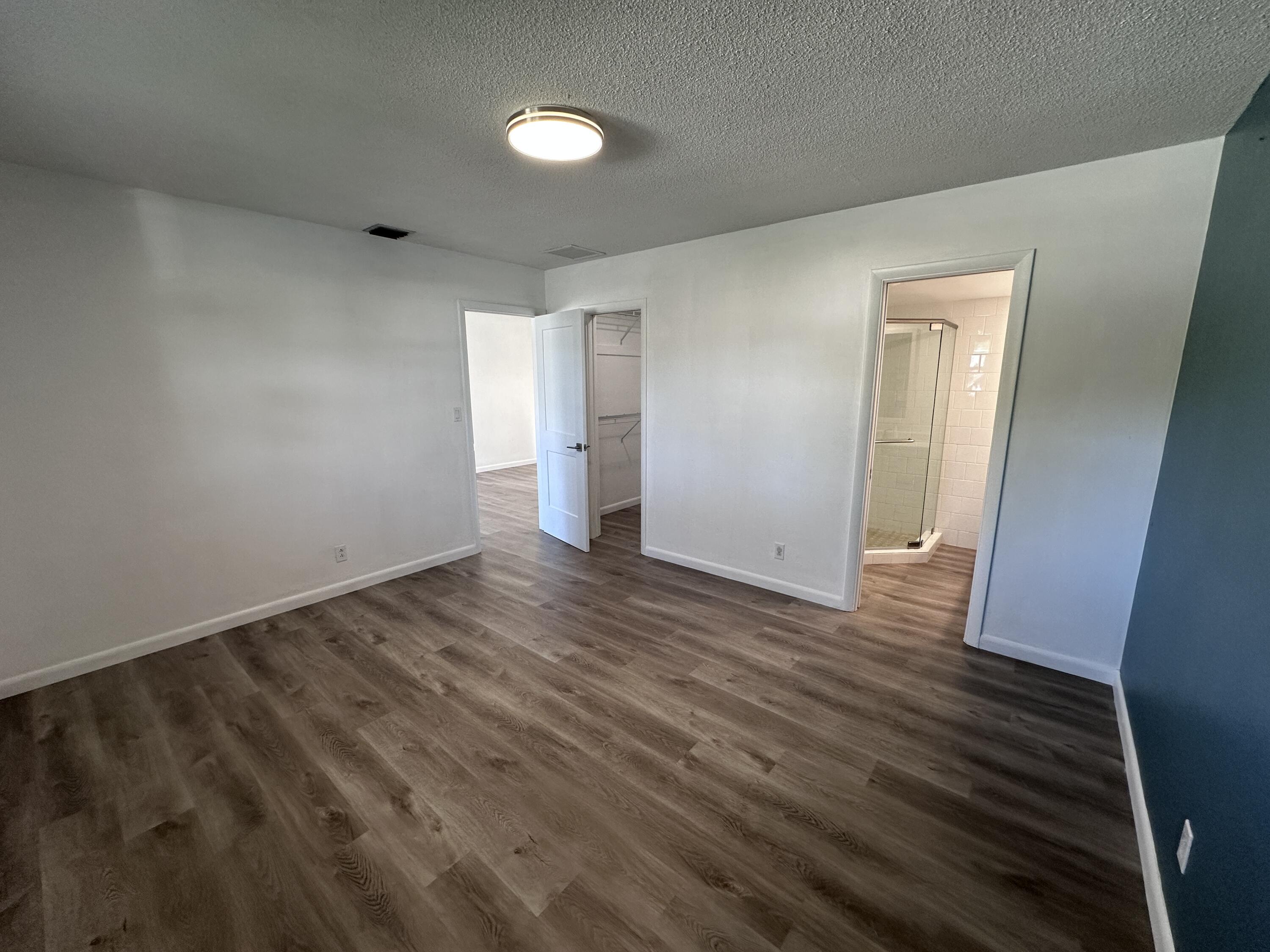 14 Ridgewood Circle Tequesta, FL 33469 - Photo 8 of 24 an empty room with wooden floor and closet