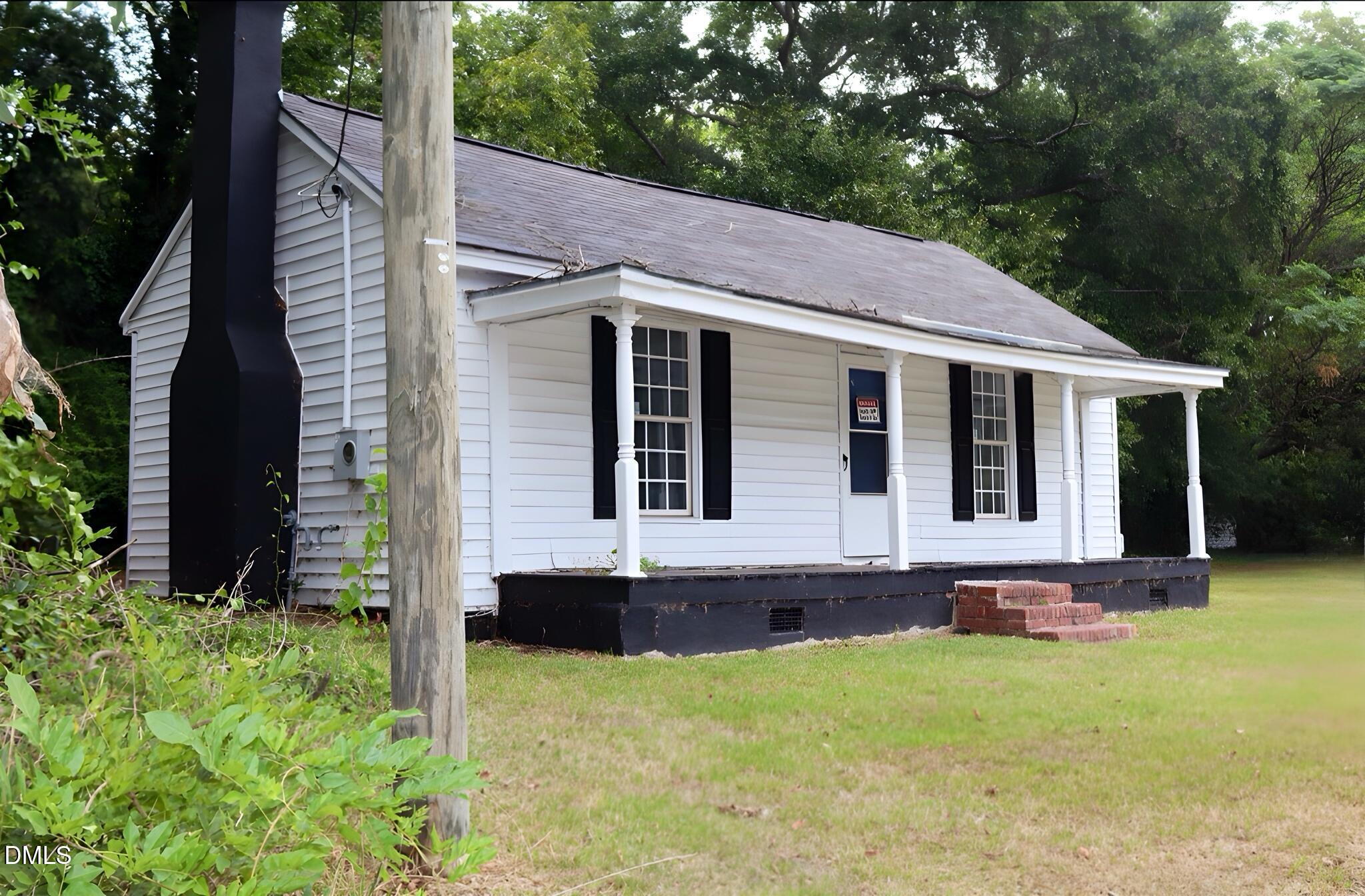 a view of house with backyard and garden