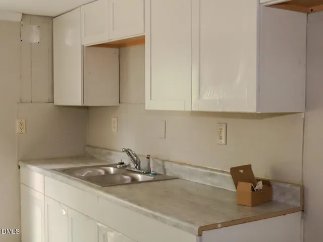 a kitchen with a sink and cabinets