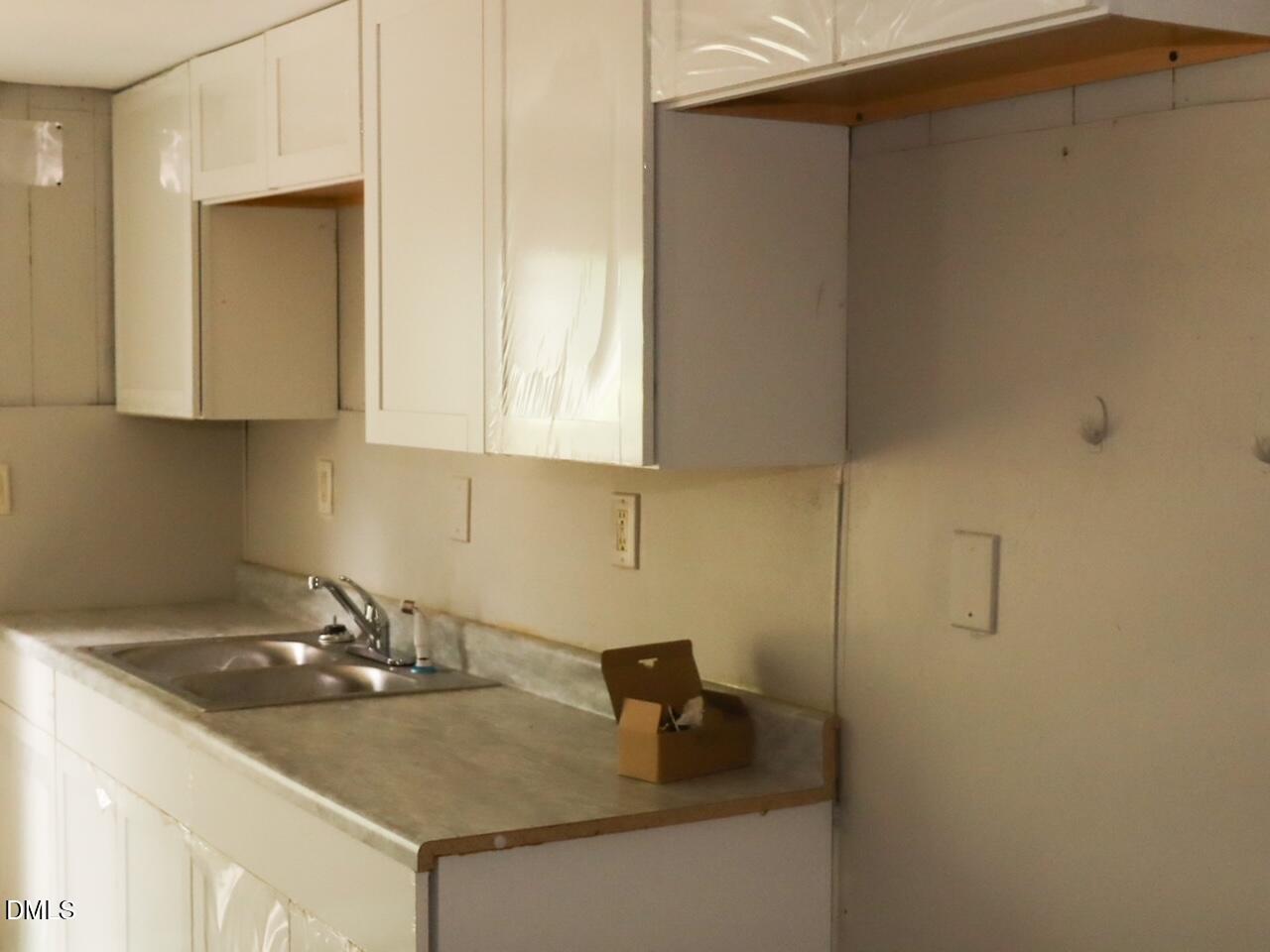 240 East Raleigh Boulevard Rocky Mount, NC 27801 - Photo 18 of 23 a kitchen with a sink and cabinets